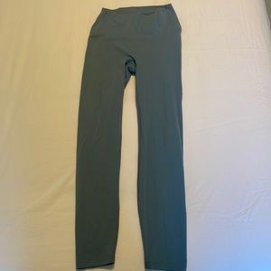Blue gray leggings. Size small worn 4 times, small hole in leg shown in pics.